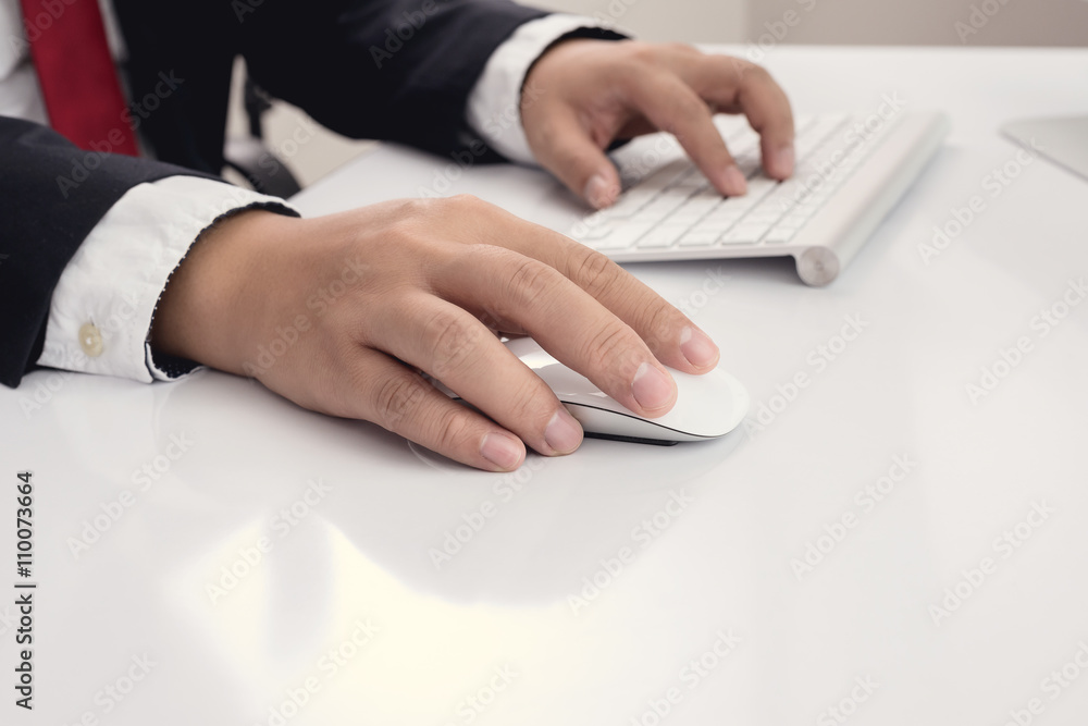 Business man hand using computer mouse