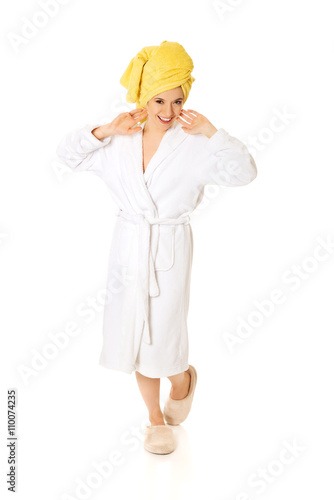 Full length young smiling woman in bathrobe