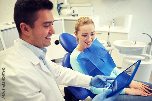 male dentist with tablet pc and woman patient