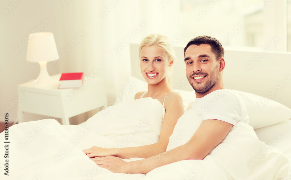 happy couple lying in bed at home happy couple lying in bed at home