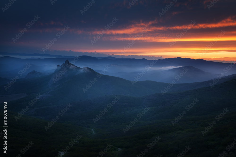 Sunset over the mountains with clouds