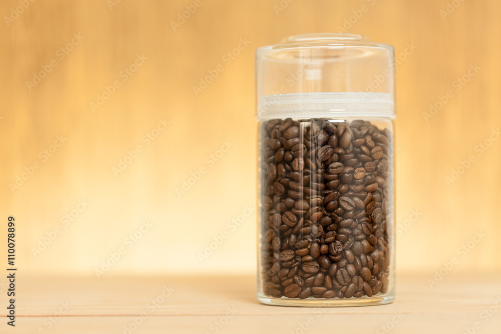 coffee bean in the glass jar on wood table coffee bean in the glass jar on wood table