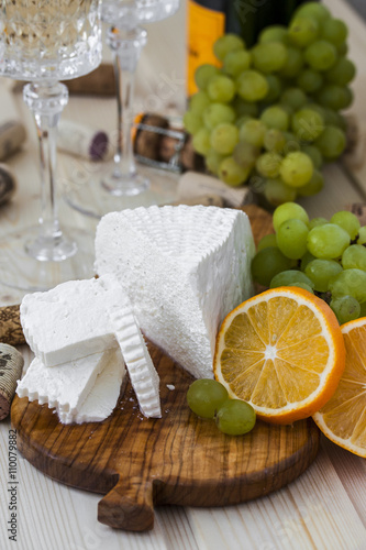cheese with grapes and a glass of champagne