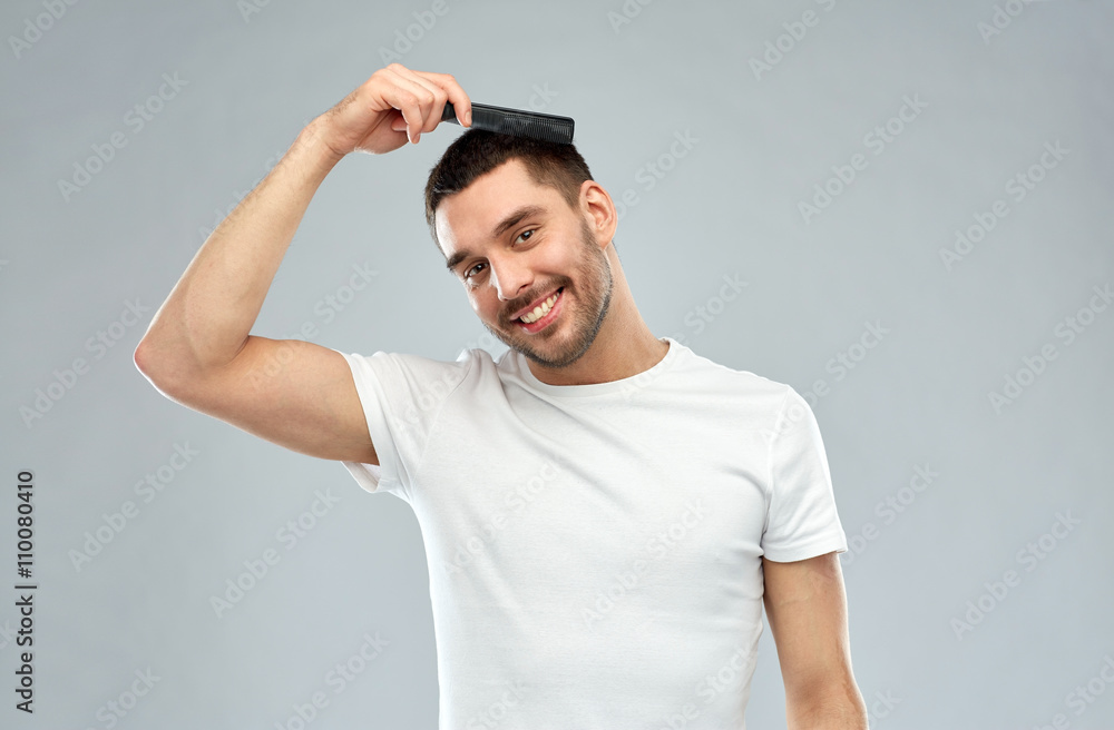 happy man brushing hair with comb over gray happy man brushing hair with comb over gray