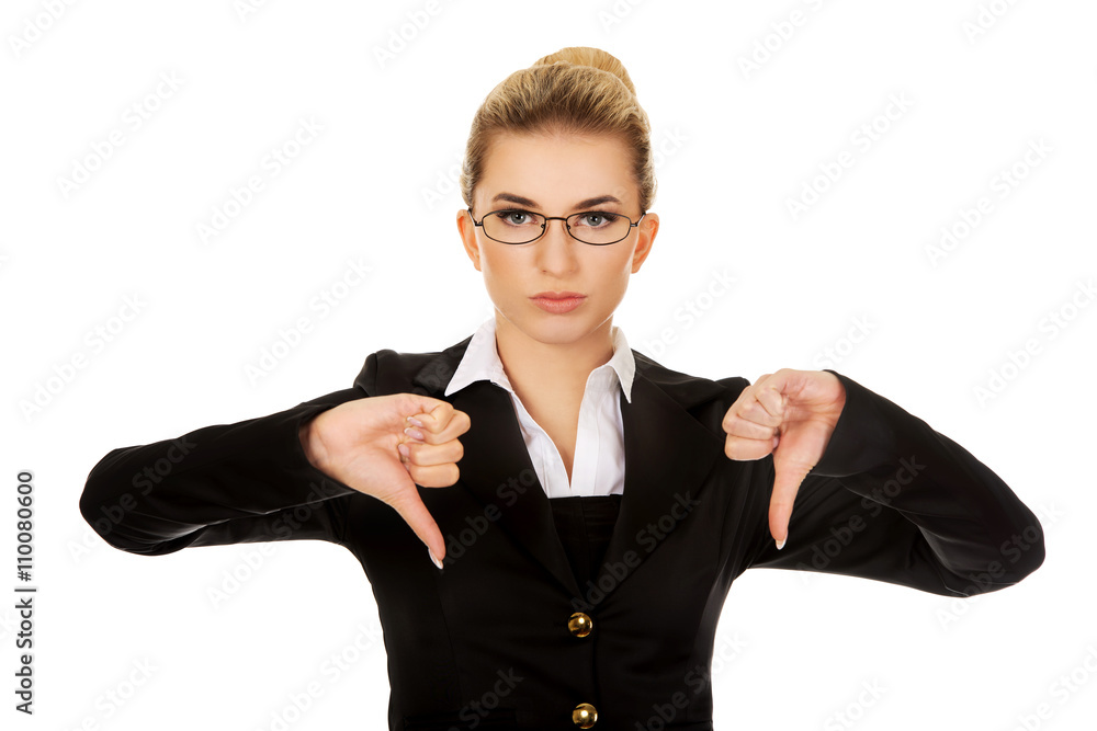Unhappy young businesswoman with thumbs up Unhappy young businesswoman with thumbs up