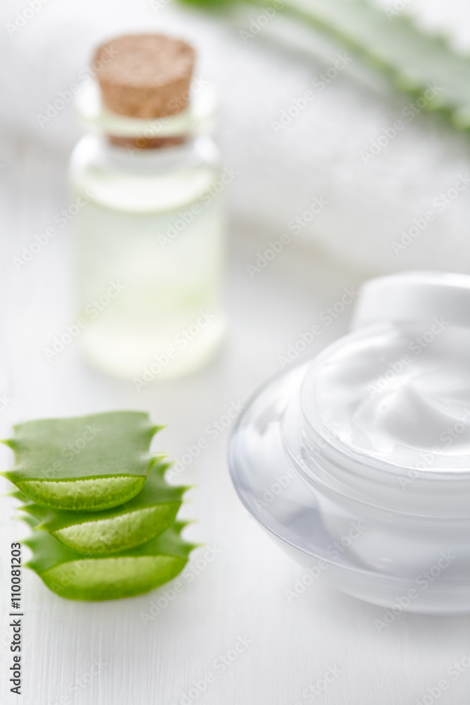 Aloe vera cosmetic cream in product container with glass bottle on white background. Skin face and body care hygiene moisture anti wrinkle natural healthy dermatology medicine therapy treatment. Aloe vera cosmetic cream in product container with glass bottle on white background. Skin face and body care hygiene moisture anti wrinkle natural healthy dermatology medicine therapy treatment.