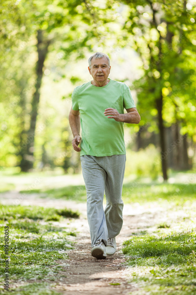 Senior man is jogging in park. Active retirement. Senior man is jogging in park. Active retirement.