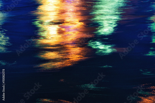 Fototapeta Naklejka Na Ścianę i Meble -  City lights reflection. Colorful glare on the water
