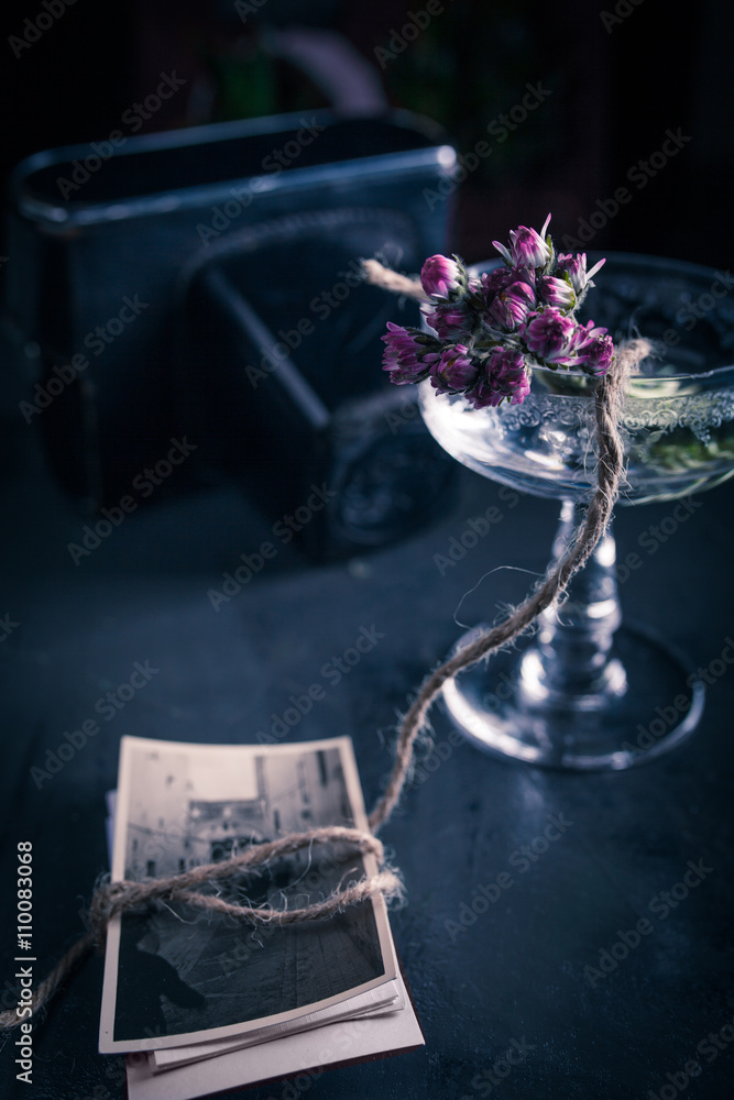 Table with a vase with flowers and photographs Table with a vase with flowers and photographs