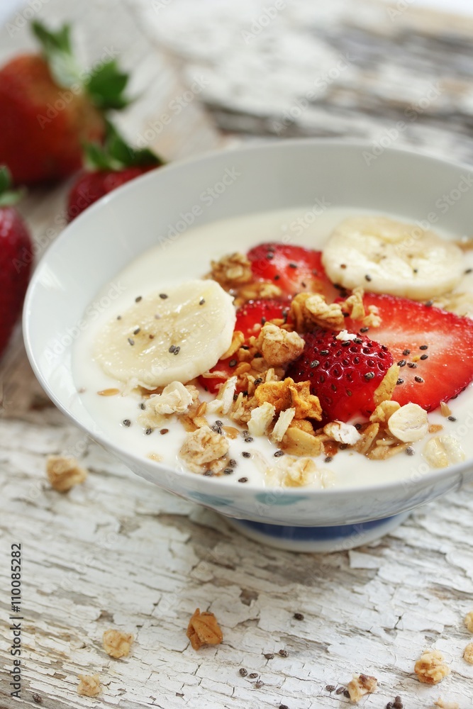 Breakfast yogurt bowl with strawberries, selective focus Breakfast yogurt bowl with strawberries, selective focus