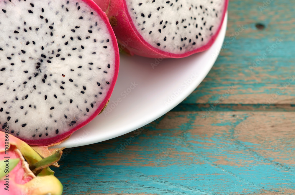 Dragon fruit / Dragon fruit on white plate, on wood background. Dragon fruit / Dragon fruit on white plate, on wood background.