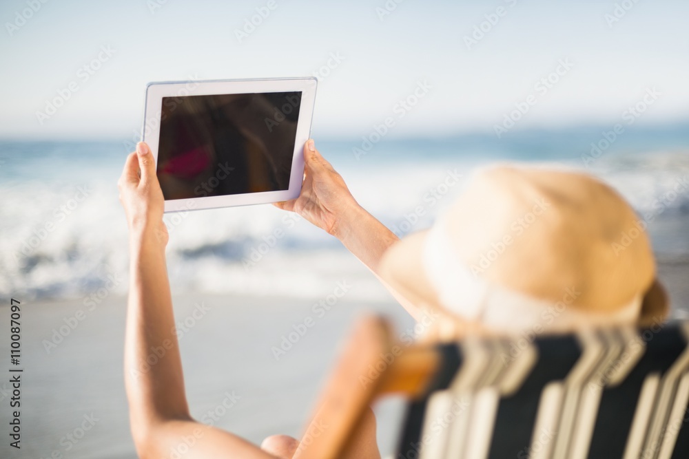 Woman talking a selfie on the digital tablet
