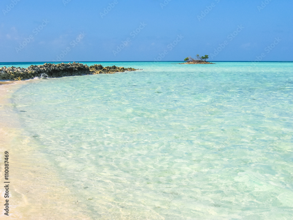 Maldives, Indian Ocean. Turquoise water of the lagoon paradise. Rocks in the sea and coral reef. North Male Atoll Asdu.