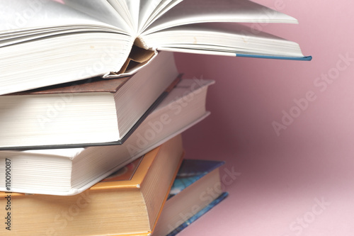 Stack of colorful books, grungy blue background, free copy space. Education essential for self improvement, gaining knowledge and success in our careers, business and personal lives.