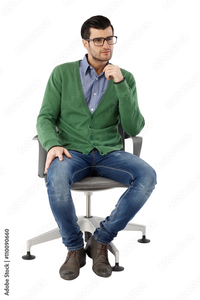 Young businessman sitting in swivel chair Young businessman sitting in swivel chair