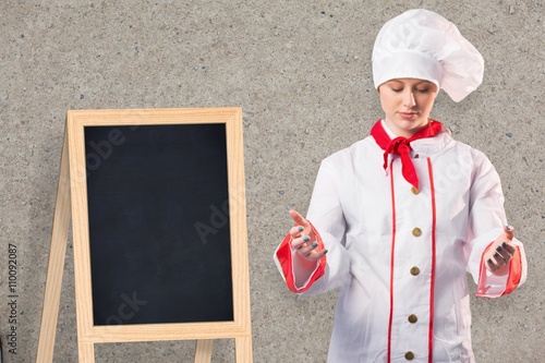 Composite image of pretty chef standing with hands out photo