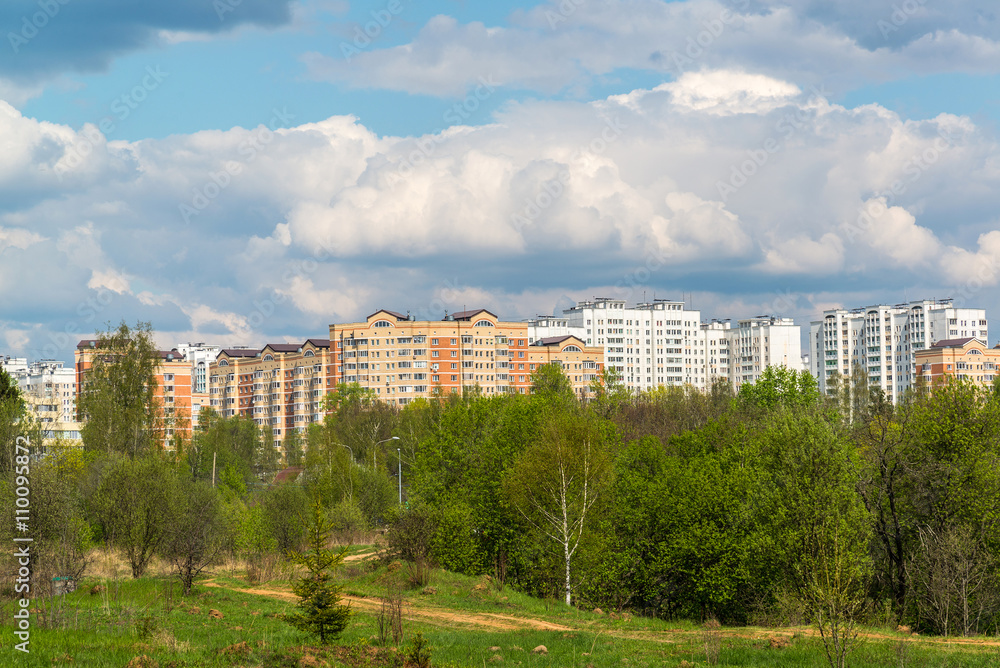 Natural summer landscape with the city in the distance