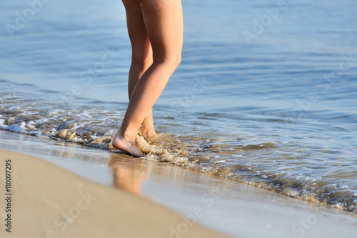 Legs walking on the beach