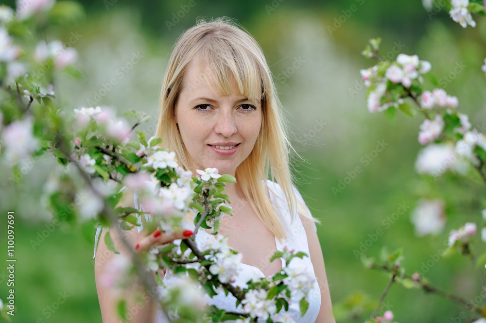 Woman in blooming apple blossoms garden Woman in blooming apple blossoms garden