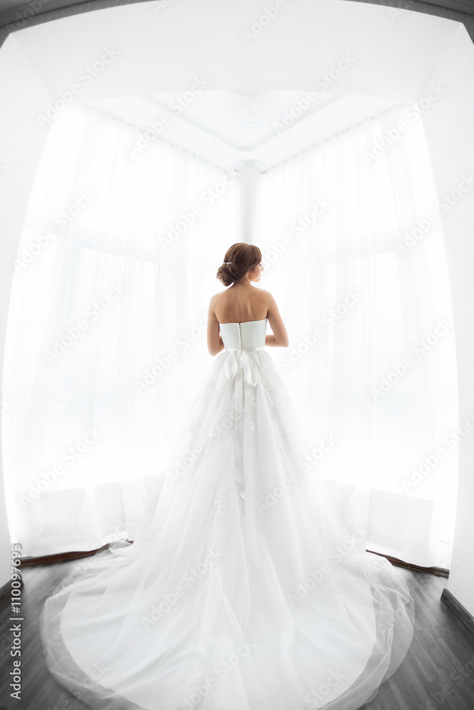 Brides beauty. Young woman in wedding dress indoors Brides beauty. Young woman in wedding dress indoors