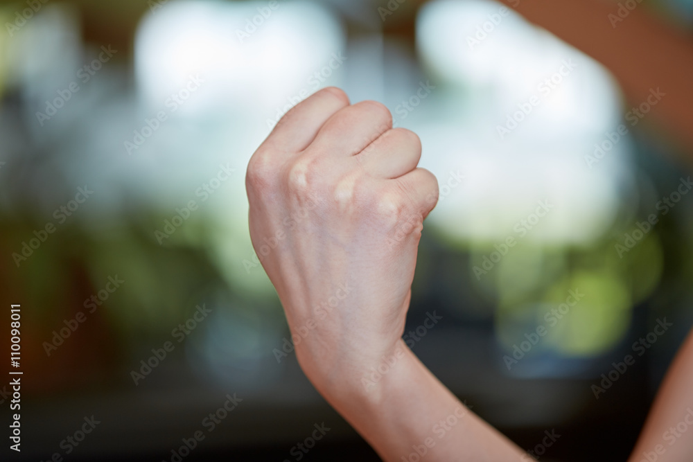 Caucasian young woman showing fist