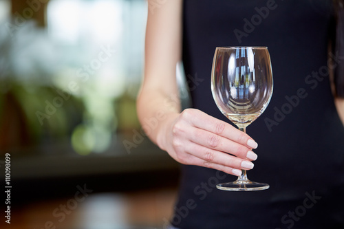 Young caucasian woman holding empty wine glass