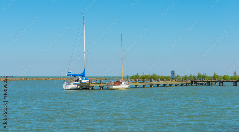 Sailboats moored at a jetty in spring