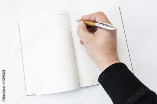 a person beginning to write on a blank book 