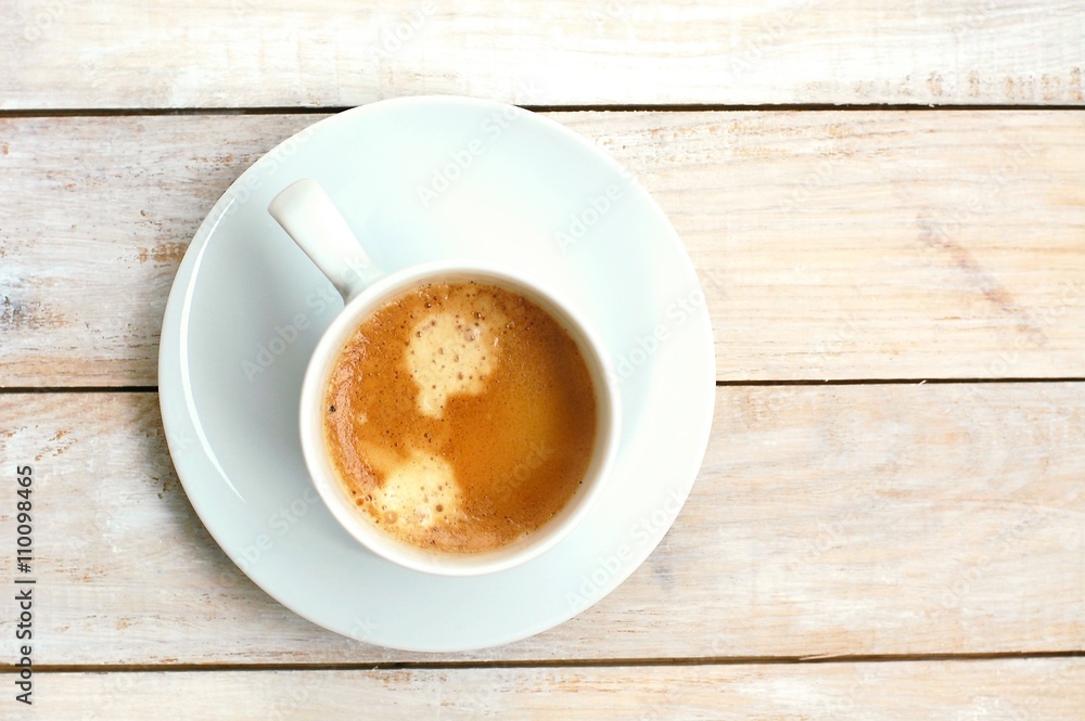 Espresso in the cup on the wooden background Espresso in the cup on the wooden background