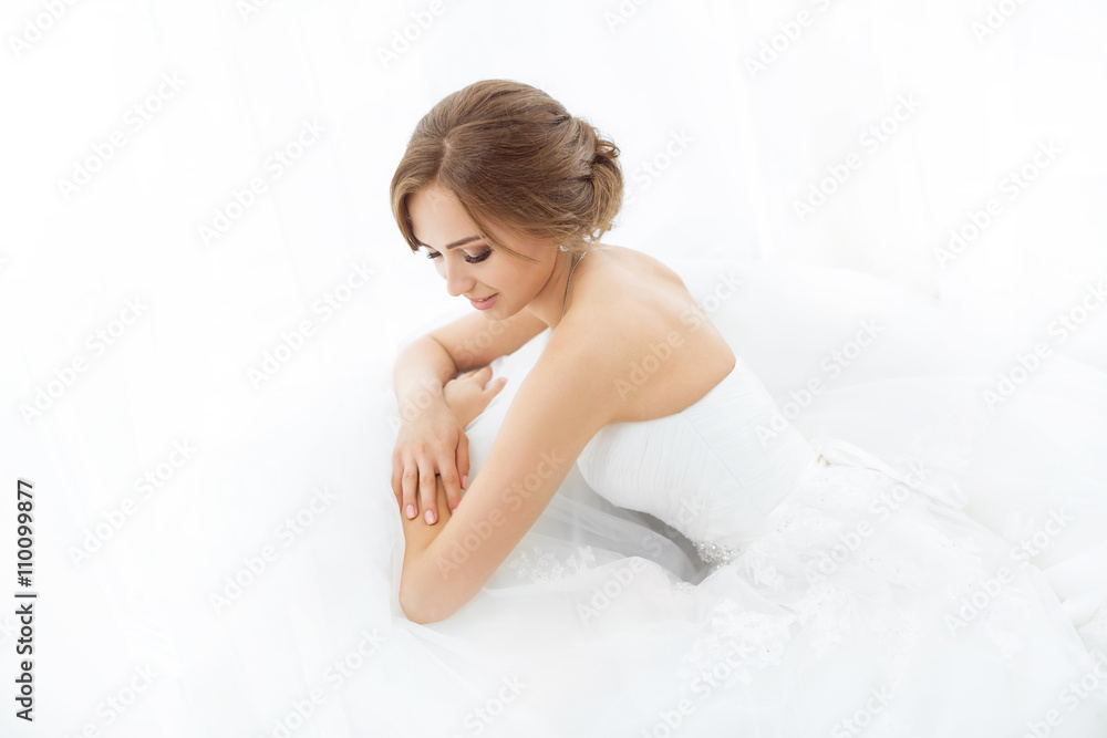 Brides beauty. Young woman in wedding dress indoors Brides beauty. Young woman in wedding dress indoors