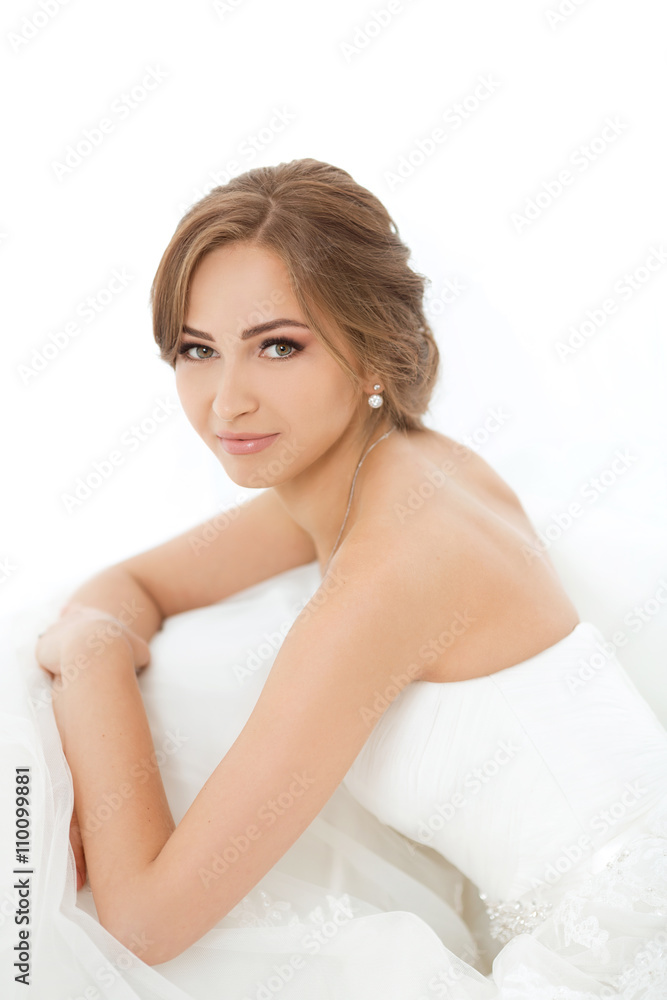 Brides beauty. Young woman in wedding dress indoors Brides beauty. Young woman in wedding dress indoors
