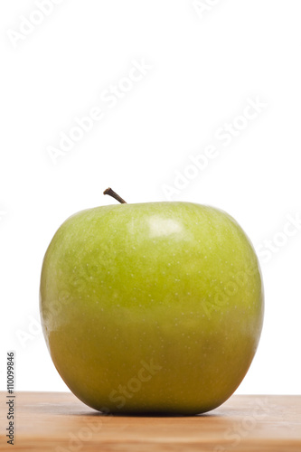 green apple on a wooden plank