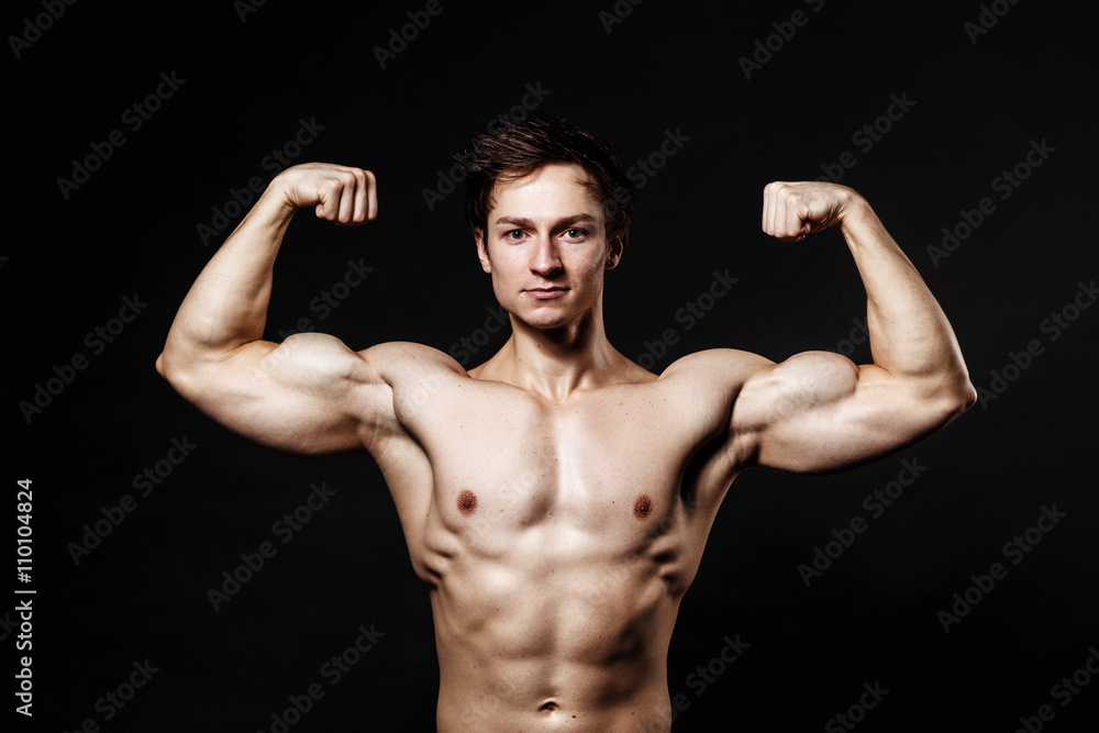 Handsome athletic man. Strong bodybuilder with six pack, perfect abs, shoulders, biceps, triceps and chest. Great fitness body. Ideal for commercial Handsome athletic man. Strong bodybuilder with six pack, perfect abs, shoulders, biceps, triceps and chest. Great fitness body. Ideal for commercial