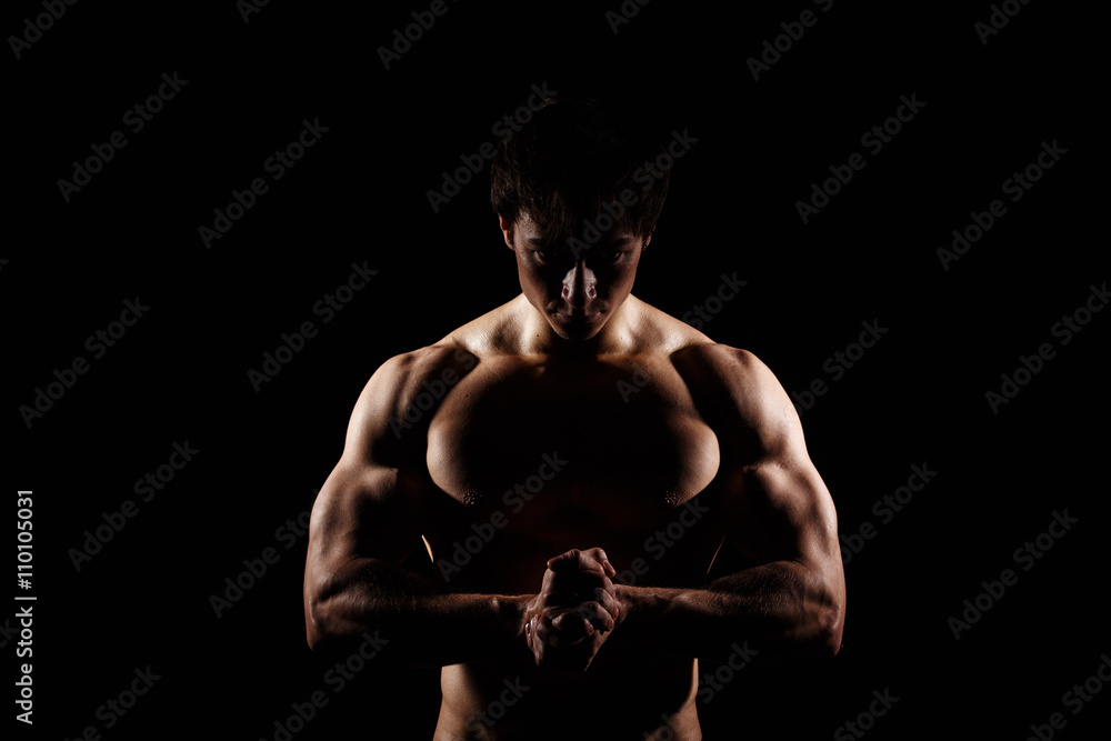 Muscular and fit young bodybuilder fitness male model posing over black  background. Perfect fitness WET body with DROPS. Ideal for commercial. ABS  Stock Photo | Adobe Stock