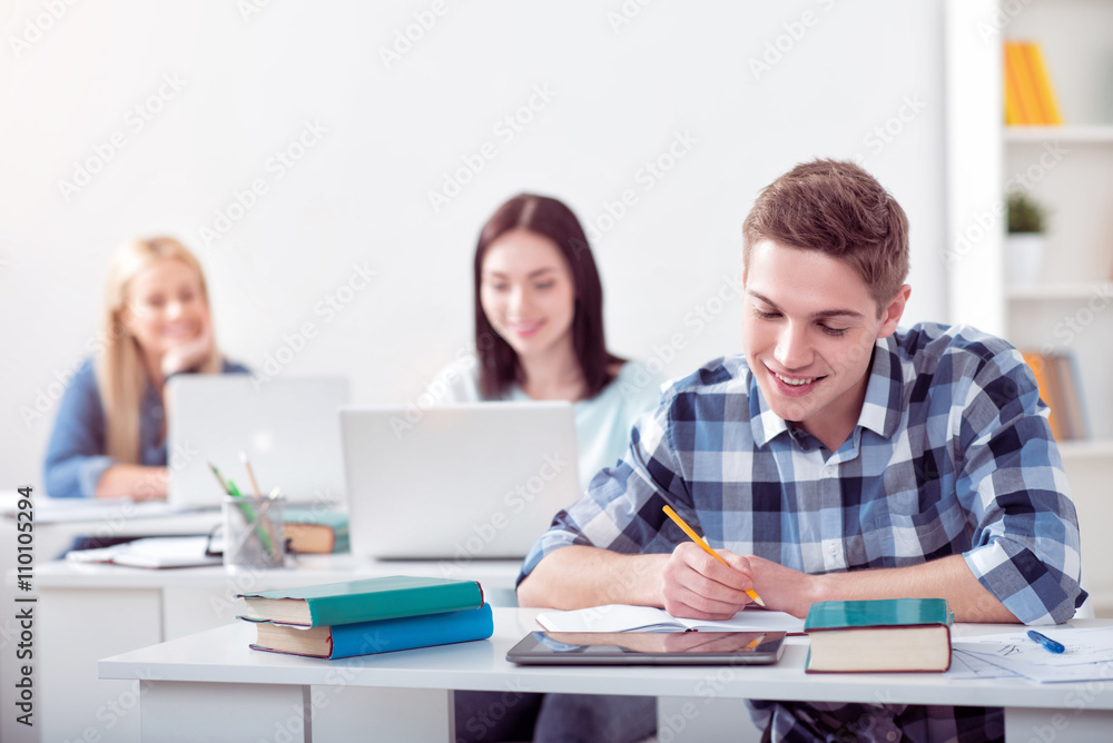 Young students studying in the classroom Young students studying in the classroom