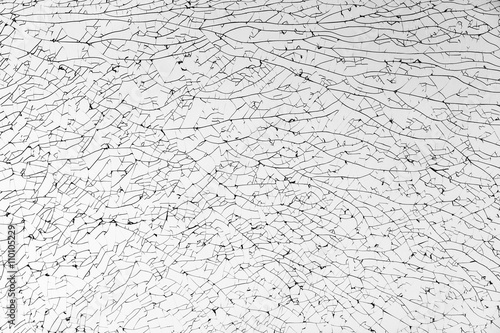 Broken glass with cracks pattern, monochrome photo