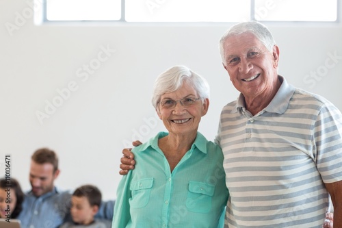Happy elderly couple smiling at camera