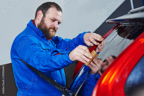 car tinting. Automobile mechanic technician applying foil 