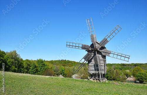 Rural landscape with old wooden windmill