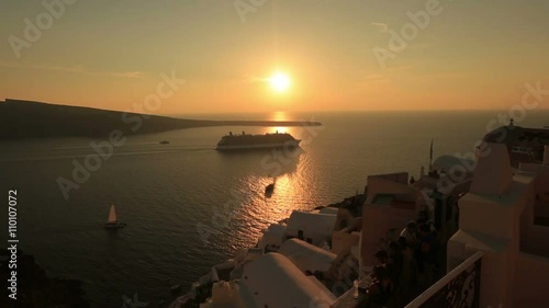 Big cruise ship on Santorini Island, Greece on breathtaking sunset photo