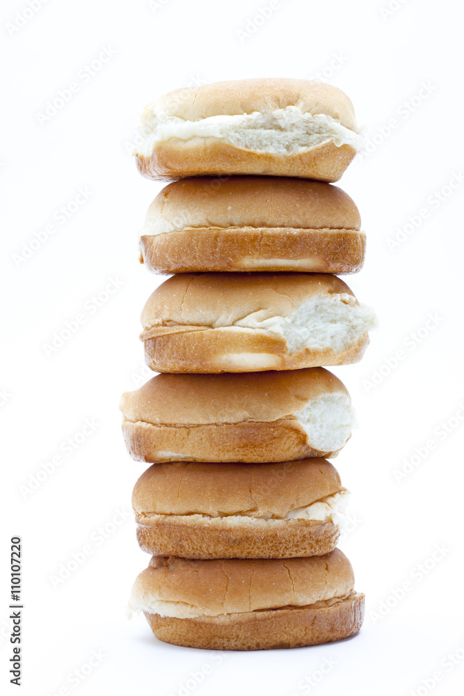 view of burger buns arranged in one top of each other. view of burger buns arranged in one top of each other.