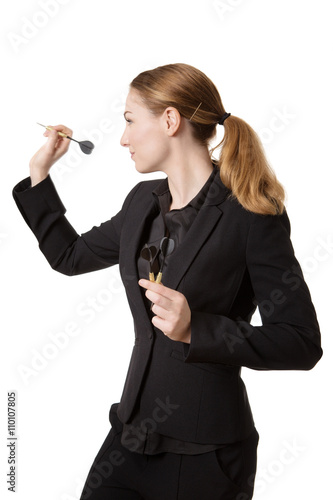 Confident businesswoman throwing dart