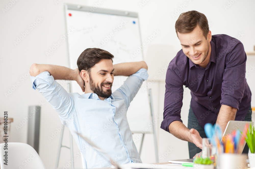 Attractive young men are working in office Attractive young men are working in office