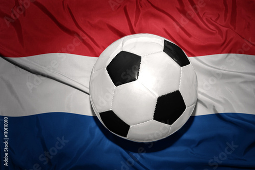 black and white football ball on the national flag of netherlands  dutch  amsterdam 