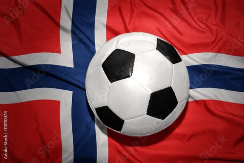 black and white football ball on the national flag of norway
