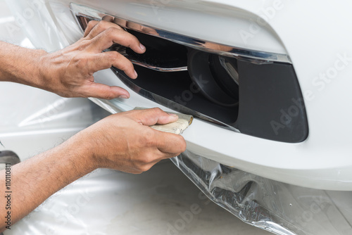 Paint protection film series : Installing paint protection film on white car © bhakpong
