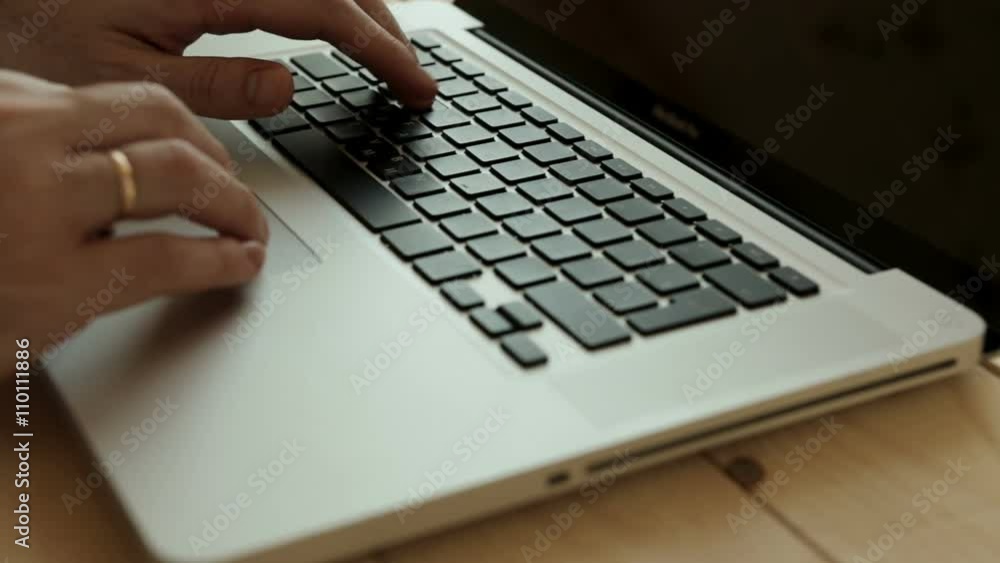 Close up of businessman hands typing on laptop computer on wooden table Close up of businessman hands typing on laptop computer on wooden table