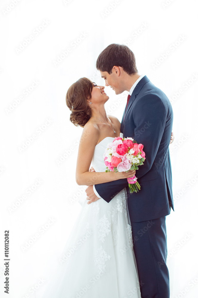 Bride and groom in very bright room at home Bride and groom in very bright room at home