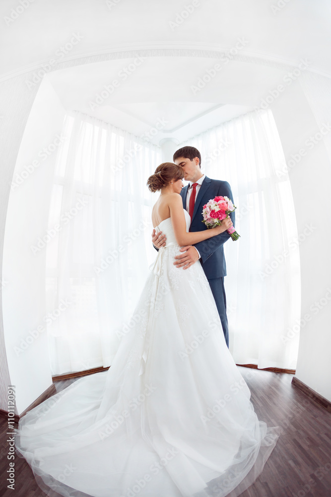 Bride and groom in very bright room at home Bride and groom in very bright room at home