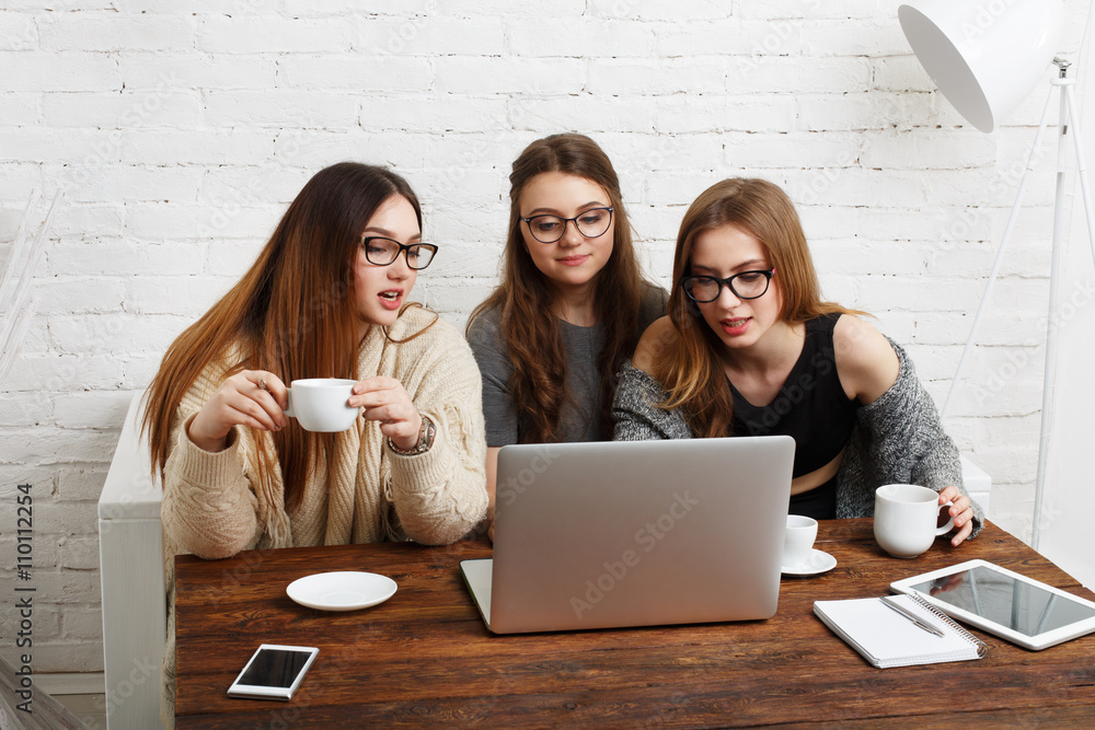 Three young women friends with laptop. Three young women friends with laptop.